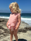 Child model wearing Peach Plaid Aria Dress with matching drawstring bloomer