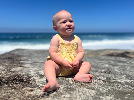 Baby model wearing the Hazel Bubble in Yellow Dandelion Print