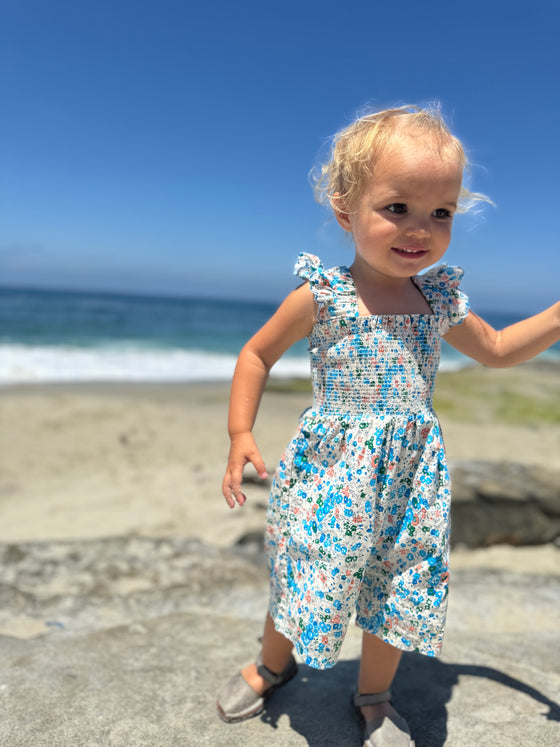 Child model wearing the Betty Bubble in Blue Floral 