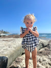 Baby model wearing Charlotte bubble in Navy Check  Eyelet 