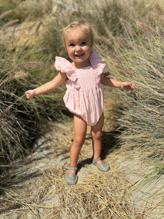 Cute baby girl wearing Pale pink ruffled baby bubble 