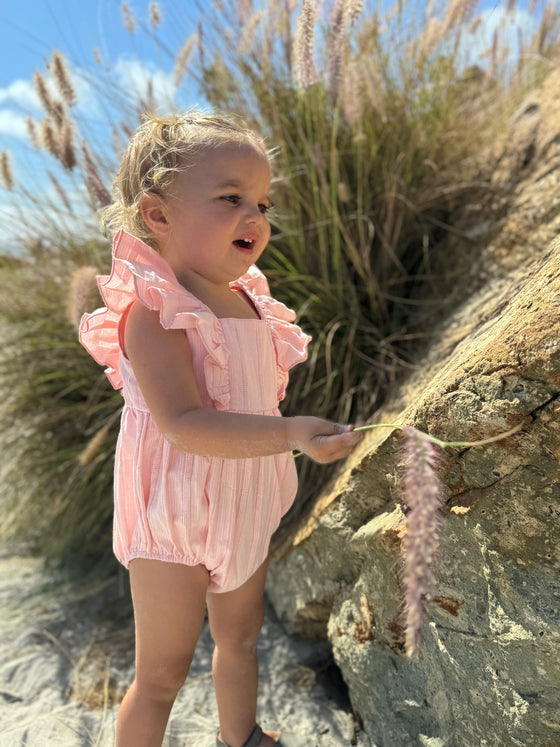 Toddler wearing Pale pink ruffled baby bubble 