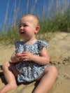 Baby at beach wearing Light blue floral print baby bubble 