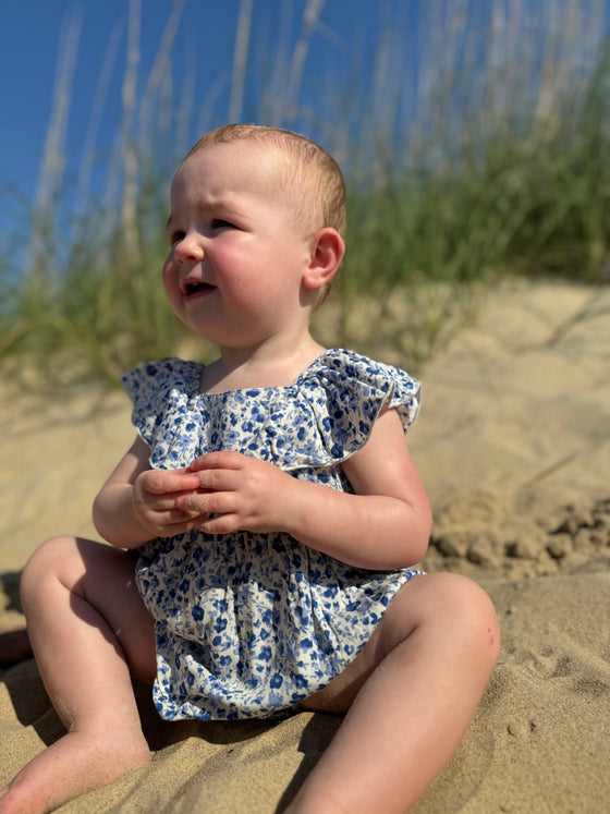 Baby at beach wearing Light blue floral print baby bubble 