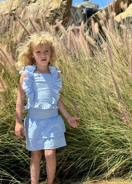 A girl at the Bech wearing matching blue tank and blue skort set 