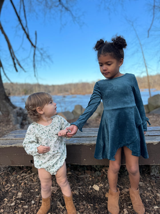Baby in floral bubble with girl in blue velvet dress