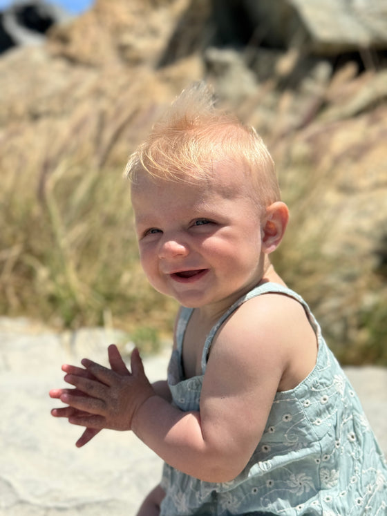 Baby at the beach showing the versatility of the Hazel Bubble in Green Eyelet